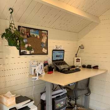 standing desk in a home office inside a kitset wooden cabin